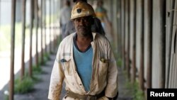 Miners walk at the end of their shift at the Anglo Platinum's Khuseleka shaft 1 mine in Rustenburg, northwest of Johannesburg, January 15, 2013.