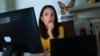FILE - Juliana Macedo do Nascimento, 36, a Deferred Action for Childhood Arrivals program recipient who moved to the U.S. from Brazil when she was 14, participates in a Zoom call for her job with United We Dream, at her apartment in Washington, Sept. 2, 2022.