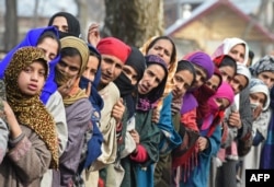 Kashmiri villagers look on during the funeral of militant commander Noor Mohammad Tantray in the Aripal village of Tral district on December 26, 2017.