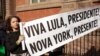 A supporter of Brazil's President Luiz Inacio Lula da Silva holds a sign outside Blair House, across from the White House, where Lula is staying in Washington, Feb. 10, 2023.