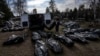 Cemetery workers unload bodies of killed civilians from a van in a cemetery in Bucha, on the outskirts of Kyiv, Ukraine, April 7, 2022.