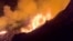 This image from video provided by the U.S. Geological Survey shows a lava lake erupting on the west caldera wall of the Kilauea volcano in Hawaii, on Dec. 23, 2024.