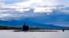 FILE - In this photo provided by U.S. Navy, a submarine departs Joint Base Pearl Harbor-Hickam, Sept. 1, 2021. 