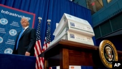 FILE - President Donald Trump arrives to speak about infrastructure at the Department of Transportation in Washington, June 9, 2017. 