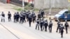 A still image taken from video shows riot police walk along a street in the English-speaking city of Buea, Cameroon Oct. 1, 2017.
