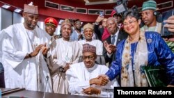 Nigerian President Muhammadu Buhari signs an agreement during African Union summit in Niamey, July 7, 2019.
