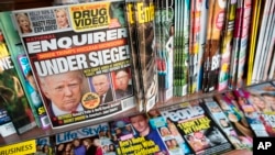 FILE - The cover of an issue of the National Enquirer is shown, featuring President Donald Trump at a store in New York, July 12, 2017. 