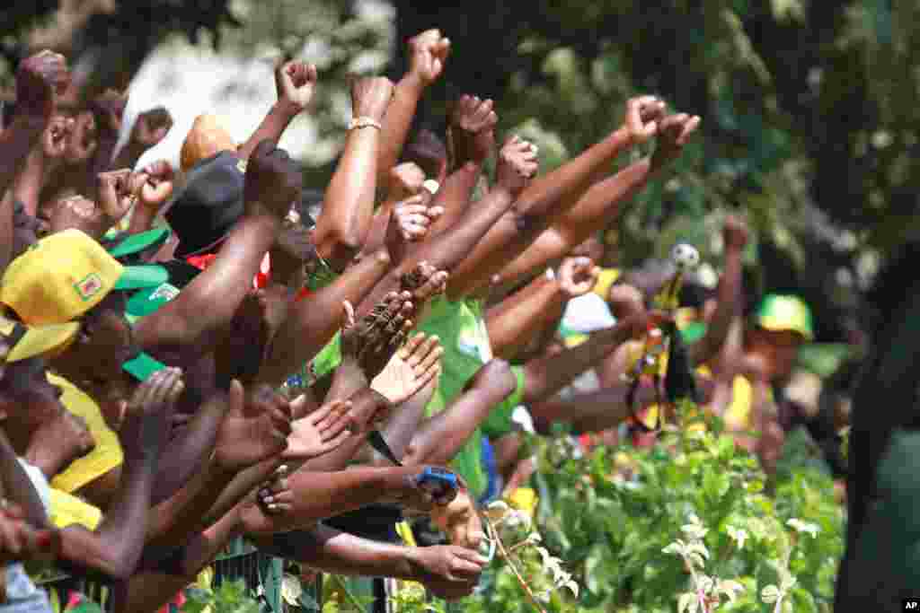 Supporters of Zimbabwean President Robert Mugabe cheer upon his arrival for the opening of the first session of the eighth Parliament of Zimbabwe in Harare. 