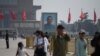 Visitors walk near a portrait of Sun Yat-sen, the first provisional president of the Republic of China, in Beijing's Tiananmen Square on Labour Day, May 1, 2020.