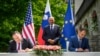 US Secretary of State Mike Pompeo, left, and Slovenia's Foreign Minister Anze Logar sign an agreement on fifth-generation internet technology as Slovenia's Prime Minister Janez Jansa stands at center, in Bled, Slovenia, Aug. 13, 2020.