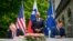 US Secretary of State Mike Pompeo, left, and Slovenia's Foreign Minister Anze Logar sign an agreement on fifth-generation internet technology as Slovenia's Prime Minister Janez Jansa stands at center, in Bled, Slovenia, Aug. 13, 2020.