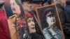 FILE - Communists carry portraits of former Soviet leader Joseph Stalin as they march along Kremlin Towers during a May Day rally in Moscow, May 1, 2015.