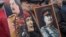 FILE - Communists carry portraits of former Soviet leader Joseph Stalin as they march along Kremlin Towers during a May Day rally in Moscow, May 1, 2015.