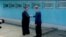 FILE - North Korean leader Kim Jong Un (left) shakes hands with South Korean President Moon Jae-in at the concrete border as both of them arrive for an inter-Korean summit at the truce village of Panmunjom, in this still frame taken from video, South Korea April 27, 2018.