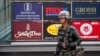 A soldier stands guard outside a shopping mall to stop protests against military rule at a shopping district in central Bangkok, June 1, 2014.
