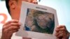 Malaysia's acting Transport Minister Hishamuddin Hussein shows the map of northern search corridor during a press conference at a hotel next to the Kuala Lumpur International Airport, in Sepang, Malaysia, March 17, 2014. 