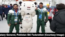 Muhammad Karim and Syed Human pose with Pyeongchang Olympics mascot.