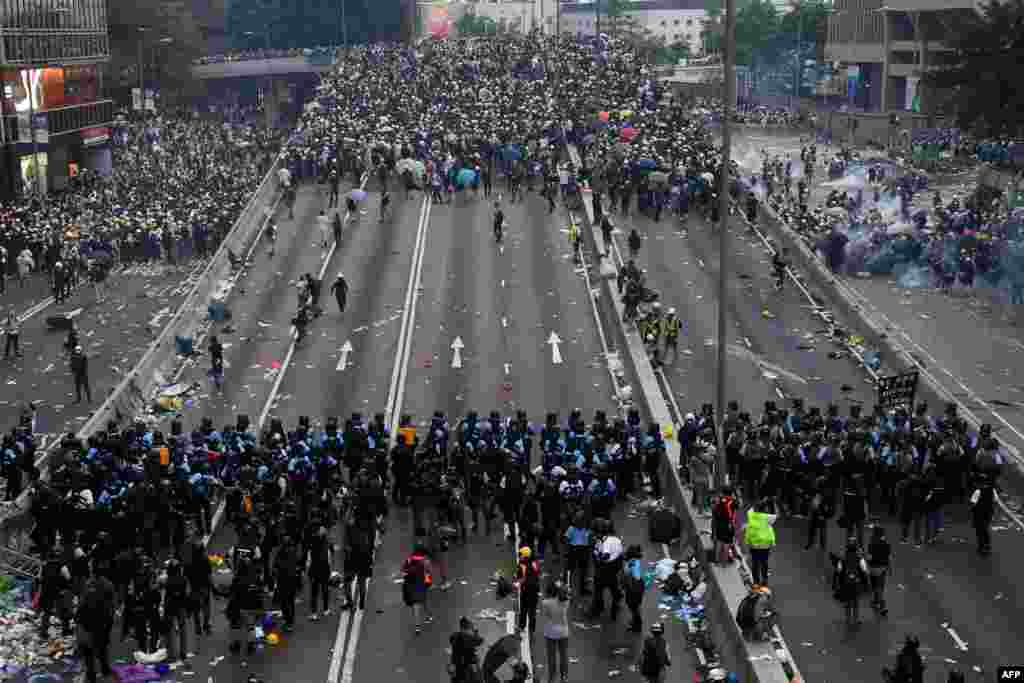 Protesters face off with police after they fired tear gas during a rally against a controversial extradition law proposal outside the government headquarters in Hong Kong.