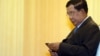 FILE - Cambodia's Prime Minister Hun Sen looks at his smartphone at a ceremony in Phnom Penh.