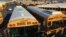 FILE - Los Angeles School District buses are parked at their bus garage in Gardena, California, Dec. 15, 2015. 
