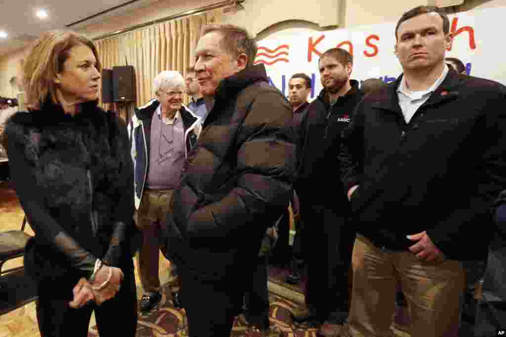 Republican presidential candidate Gov. John Kasich, R-Ohio, talks with his wife Karen before speaking at his last town hall meeting before Tuesday's first in the nation presidential primary, Feb. 8, 2016, in Manchester, N.H.