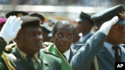 FILE - Zimbabwean President Robert Mugabe (C), surrounded by members of the military, is seen attending 25th anniversary Independence celebrations in Harare, Zimbabwe, April 18, 2005.