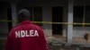 FILE - A National Drug and Law Enforcement Agency (NDLEA) official searches for evidence of illegal substances in Obinugwu village in southeast Nigeria, Nov. 22, 2018.