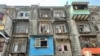 Under a redevelopment project, high rise buildings will replace these dilapidated century-old tenements called BDD Chawls in the heart of Mumbai and give the residents 500 square foot apartments in exchange. (Anjana Pasricha/VOA)