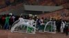 Angry football fans break the players' bench as violence broke out at the World Cup 2022 qualifying football match between Nigeria and Ghana at the Moshood Abiola National Stadium in Abuja, March 29, 2022.