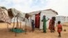 Children stand near a shelter at the Bogo IDP camp in Maroua, Cameroon, April 28, 2022. Cameroon is using this year's "Boxing Day," a day of giving following Christmas, to assist children displaced by the country's separatist conflict.