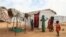 Children stand near a shelter at the Bogo IDP camp in Maroua, Cameroon, April 28, 2022. Cameroon is using this year's "Boxing Day," a day of giving following Christmas, to assist children displaced by the country's separatist conflict.