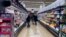 FILE - Customers shop at a grocery store in Mount Prospect, Ill., United States on April 1, 2022.