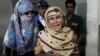 Rukhsana Bibi, center, mourns her daughter, polio worker Madiha Bibi, killed by unknown gunmen, at a local hospital in Karachi, Pakistan, Dec. 18, 2012. 