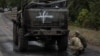 Ukrainian servicemen inspect a destroyed Russian military vehicle, as Russia's attack on Ukraine continues, in Kharkiv region, Ukraine, Sept. 13, 2022. 