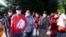 FILE - Migrants hold Red Cross blankets after arriving at Union Station near the U.S. Capitol from Texas on buses, April 27, 2022, in Washington.
