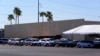 Dozens of vehicles line up to get provisions at St. Mary's Food Bank on June 29, 2022, in Phoenix. Long lines are back at food banks around the U.S., as Americans overwhelmed by inflation and higher gas prices seek help feeding their families.