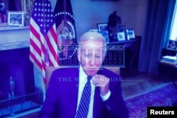 U.S. President Joe Biden appears on screen from the Roosevelt Room at the White House in Washington, July 26, 2022.