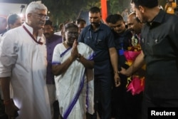 Droupadi Murmu, India's first president from the tribal community, walks to a welcoming ceremony in New Delhi, July 21, 2022.