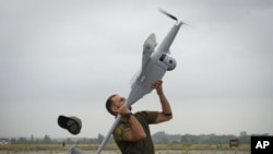 A Ukrainian soldier launches FlyEye WB Electronics SA, a Polish reconnaissance drone in Kyiv region, Aug. 2, 2022.