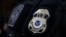 FILE - The badge of a field office director for the U.S. Immigration and Customs Enforcement's Enforcement and Removal Operations in Hawthorne, California, on March 1, 2020.
