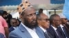 Former al-Shabab group co-founder and spokesperson Mukhtar Robow sits among colleagues after he was named as the minister in charge of religion by Prime Minister Hamza Abdi Barre in Mogadishu, Somalia, Aug. 2, 2022.