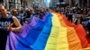FILE - Reveler carry a LTBGQ flag along Fifth Avenue during the New York City Pride Parade on June 24, 2018.