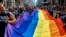 FILE - Reveler carry a LTBGQ flag along Fifth Avenue during the New York City Pride Parade on June 24, 2018.