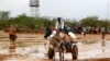 Newly arrived Somali refugees ride a donkey along the street at the Ifo Extension refugee camp in Dadaab, near the Kenya-Somalia border, October 19, 2011.