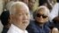 Former Khmer Rouge leaders Khieu Samphan, left, and Nuon Chea, right, look on during the funeral for Khieu Ponnary, the first wife of Khmer Rouge leader Pol Pot, in 2003. 