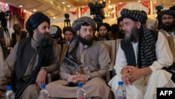 Bashar Noorzai (R), a warlord and Taliban associate, sits along with the acting defence minister of Afghanistan Mohammad Yaqoob Mujahid (C) and Taliban's acting first deputy prime minister Abdul Ghani Baradar (L) during a press event at the Intercontinental Hotel in Kabul on September 19, 2022.