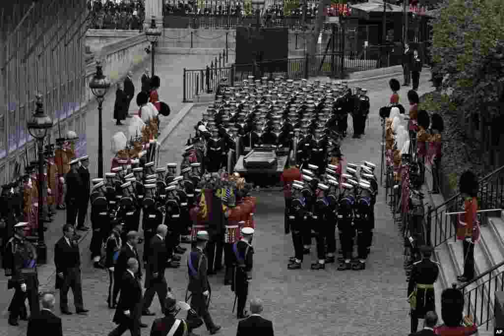 The coffin of Queen Elizabeth II is loaded on to a gun carriage pulled by Royal Navy soldiers to go from Westminster Hall for her funeral service in Westminster Abbey in central London, Sept. 19, 2022. 