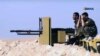 FILE - U.S.-backed fighters take position during fighting with the Islamic State group in the village of Laqtah, north of Raqqa, Syria, in this still from a video provided by the Hawar News Agency, Nov. 7, 2016.