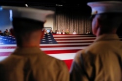 FILE - Army members hold the U.S. flag as they attend an annual Memorial Day ceremony at the Intrepid Museum in New York, May 29, 2017.