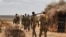 FILE - A handout photo taken June 10, 2016, and released by AMISOM shows soldiers serving under the African Union Mission in Somalia (AMISOM) on foot patrol in Halgan village, Hiran region. Civilians in the region have been targetted by recent al-Shabab a